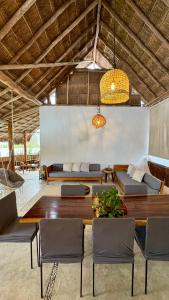 a dining room with a table and chairs at Casa Luma Hostel Boutique in Tulum