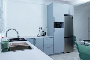 a kitchen with a refrigerator and a sink at Spacious Beach house in Buccament