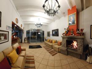 a living room with a couch and a fireplace at Plaza Mayor Hotel in Puno