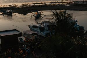 a group of boats are docked in the water at Nipper Resort & Villa Nusa Dua in Ujung