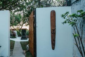 a wooden spear on a wall next to a fence at Nipper Resort & Villa Nusa Dua in Ujung +96 photos