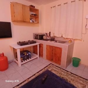 a kitchen with a sink and a counter top at Lowela Stays in Kitengela 