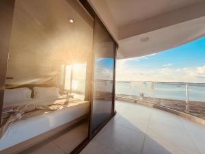 a bedroom with a bed and a view of the ocean at HC Hotel in Sihanoukville +29 photos