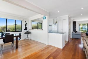 a kitchen and living room with a table and a couch at IL Mare - "Expansive Ocean Views" in Apollo Bay