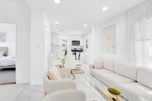 a living room with white furniture and white walls at Luxury 5 BR 2BA Apt NYC Sleeps 16 with Free Parking! in Yonkers