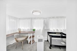 a bedroom with a desk and a bed and a table at Luxury 5 BR 2BA Apt NYC Sleeps 16 with Free Parking! in Yonkers