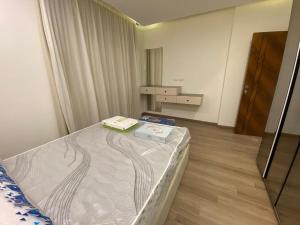 a bedroom with a bed with a book on it at Hotel Apartment View Nile Maadi in Cairo