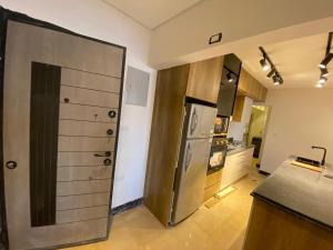 a kitchen with a refrigerator and a counter top at Hotel Apartment View Nile Maadi in Cairo