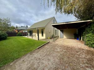 a house with a garage and a grass yard at 15b Caverhill Close in Hanmer Springs