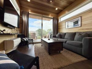 a living room with a couch and a large window at Escalante Escapes Fox Tail- Loft Escape in Escalante +23 photos