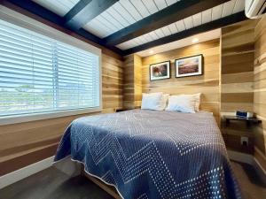a bedroom with a bed in a room with a window at Escalante Escapes Fox Tail- Loft Escape in Escalante