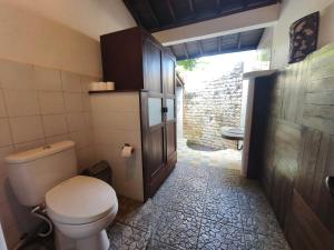 a bathroom with a toilet and a sink at Cozy two bed room with swiming pool in Ubud +20 photos