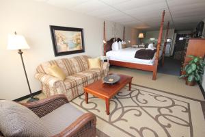 a living room with a couch and a bed at St Andrews Inn & Suites in Saint Andrews