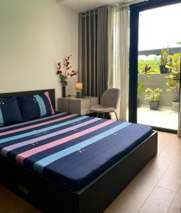 a bedroom with a large bed and a large window at The Luxe Collection Sun Avenue Riverside District 2 Suite in Ho Chi Minh City +97 photos