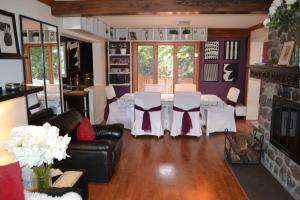 a living room with a table and chairs and a fireplace at Amis des Laurentides - B&B in Saint-Sauveur-des-Monts