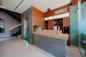a restaurant with a counter in a building at Sans Vibes 4 5 Hotel in Blentuk Dua +52 photos