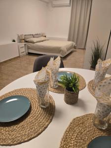a table with plates and glasses on top of it at Студио Ива 2 in Sliven