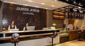 two women sitting at a bar in a restaurant at James Joyce Coffetel· Wuhan Wangjiawan Taojialing Metro Station in Wuhan