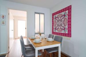 a dining room with a table and chairs and a picture on the wall at Stylish 2BR Brunswick Home in Melbourne
