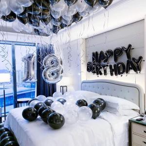a bed with balloons and a happy birthday sign on it at Majestic Residence KL in Kuala Lumpur