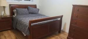 a bedroom with a bed with a dresser and a drawer at Full house, 3 BDR, 2WR, free Parking , extra beds in Windsor