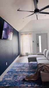 a living room with two beds and a flat screen tv at Little Nyssa Home away from Home in Houston
