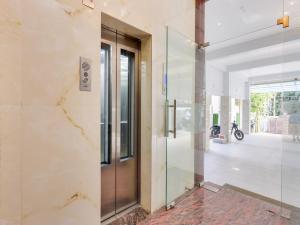 a glass door in a lobby with a motorcycle in the background at Townhouse Royal Inn in Guwahati