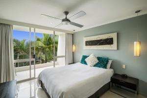 a bedroom with a bed and a large window at Noosa Harbour Resort in Noosa Heads +120 photos