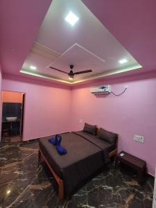 a bedroom with a bed and a purple wall at Svayambhu Stay in Bhogwe