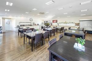 a dining room with tables and chairs and a chalkboard at Chinchilla Tourist Park in Chinchilla