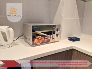 a microwave oven on a counter in a kitchen at Metropolitan Stay at HYVE SOHO Cyberjaya in Cyberjaya +13 photos