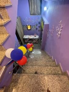 a hallway with colorful chairs and a purple wall at Shri Sanwariya Dham Near By Mathura Junction Railway Station in Mathura +3 photos