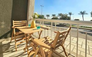 a wooden table and two chairs on a balcony at Stunning and warm near East Hub in Madinaty in Madinaty
