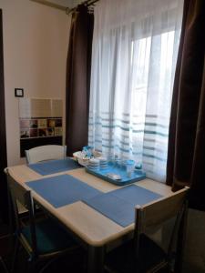 a table with a blue table cloth on top of it at Erika Vendégház in Mogyoród