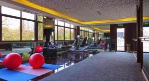 a gym with a bunch of people exercising in it at Eden Club House in Tongxiang