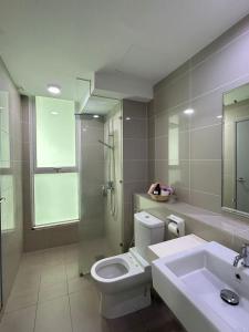 a bathroom with a toilet and a sink and a shower at Sutera Avenue Kota Kinabalu City Centre LW Suites in Kota Kinabalu