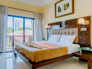 a bedroom with a large bed and a balcony at Lotusland Resort in Jomtien Beach +102 photos