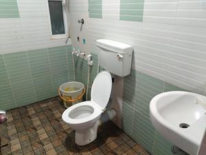 a bathroom with a toilet and a sink at Madurai Grands Inn in Madurai