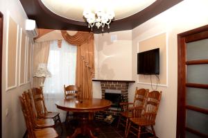a dining room with a table and chairs and a fireplace at Hotel Borisoglebsk in Borissoglebsk
