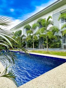 a swimming pool in front of a building at Sapphire Boutique Resort in Panglao Island