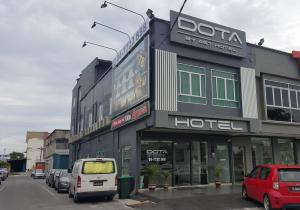 a hotel with cars parked in front of it at DOTA Hotel in Alor Setar