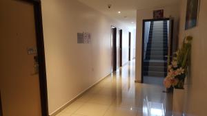 a hallway with a mirror and stairs in a building at DOTA Hotel in Alor Setar