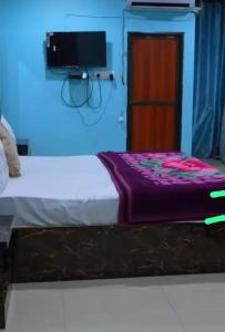 Katil atau katil-katil dalam bilik di Satyam Guest House