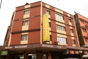 un gran edificio de ladrillo rojo con un cartel. en New Swanga en Nairobi