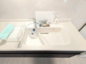 a white bathroom sink with a faucet on a counter at Vacation House 3 in Funabashi +88 photos