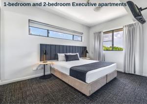 a bedroom with a bed and two bedroom executive apartments at Hudson Parap in Darwin