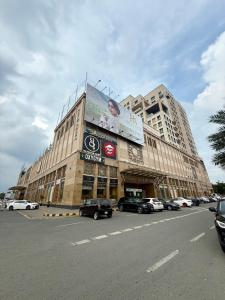 a large building with a billboard on the side of it at Gold Crest Apartments - 1 2 3 4 Bedroom By luxuryapartmentspk in Lahore