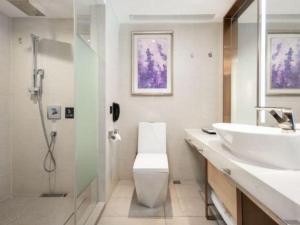 a bathroom with a sink and a toilet and a shower at Lavande Hotel·Wuhan Qingshan Zhongyuan Plaza in Wuhan +75 photos