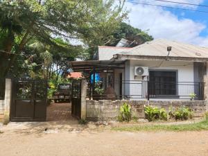 a house with a gate and a fence at Yaga's Stay INN save in Impasugong