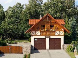 a house with a garage in a driveway at Skiapartman in Batizovce